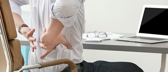 Man suffering from ergonomic back pain