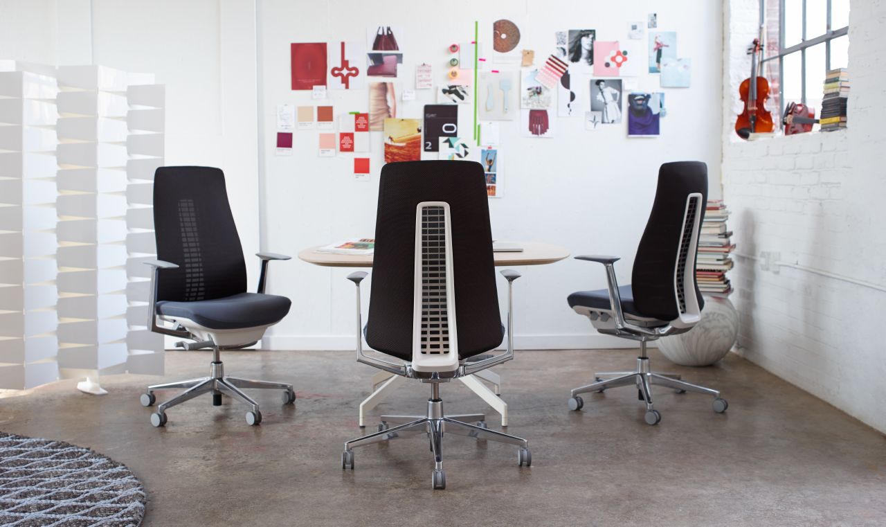 three black grey haworth fern task chairs in a meeting space