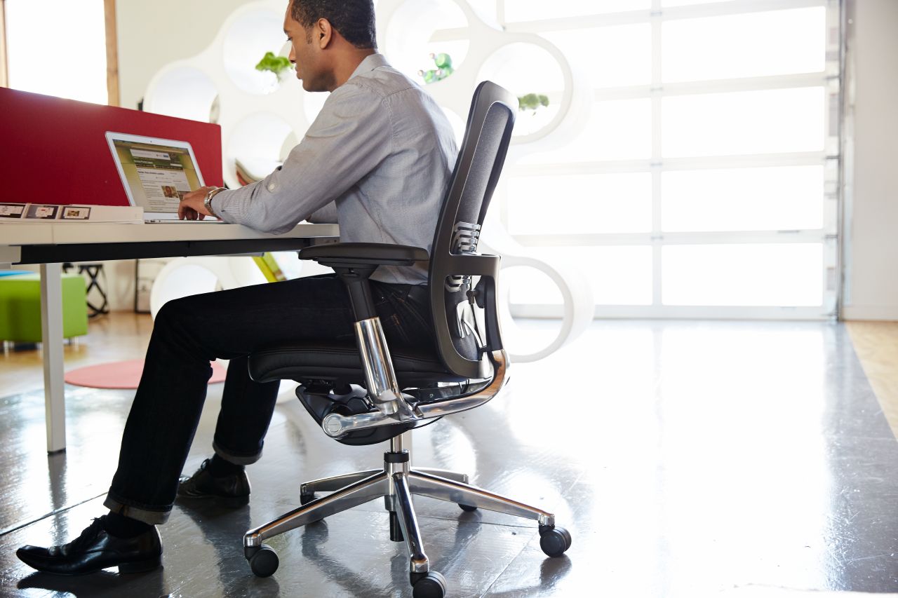 man using haworth zody task chair to work at desk