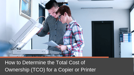Man and woman using a photocopier and wondering what it will cost over it's lifetime
